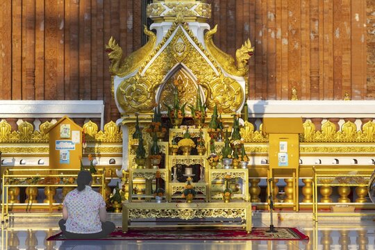 Altar for offerings to Buddha, Dharma and Sangha, in front of the chedi at Wat Phra That Phanom, temple complex in Amphoe That Phanom, Nakhon Phanom Province, Isan, Thailand