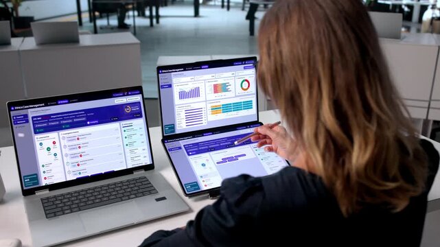 Mature Woman Uses Dual Touchscreen Laptops