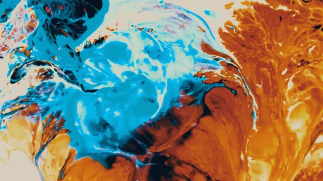 Deep blue and vibrant orange paint pigments merging in artistic motion