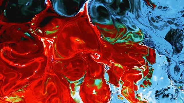 Abstract red and blue liquid paint mixing on a flat creative surface