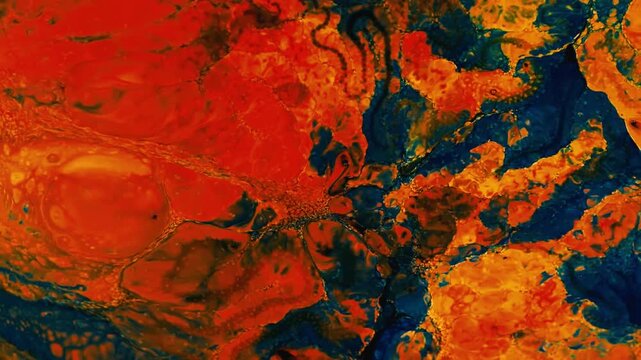 Vibrant orange and deep blue acrylic paint swirling in abstract art