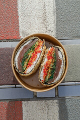 Sushi burger on road markings. Delivery box. Art photo. © Cavan
