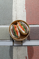 Sushi burger on road markings. Delivery box. Art photo © Cavan
