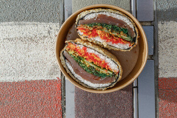 Sushi burger on road markings. Delivery box. Art photo © Cavan