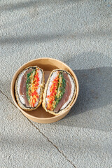 Sushi burger on road markings. Delivery box. Art photo © Cavan