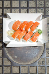 Philadelphia roll with salmon on a metal wire rack. Delivery box © Cavan