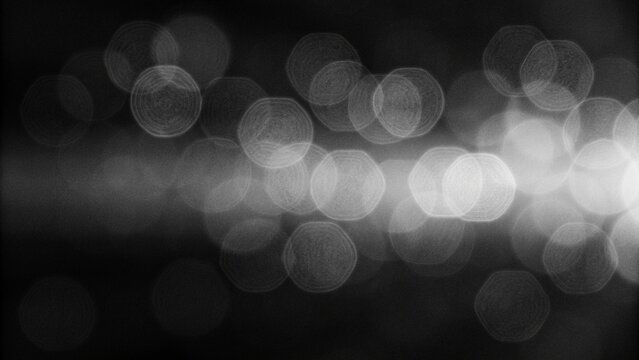 Retro film overlay with scratches, dust and light leaks on black and white background, vintage grain texture for cinematic editing, photo effects and distressed design.