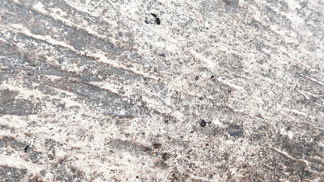 Worn Rough Concrete Pavement with Faded Tire Tracks