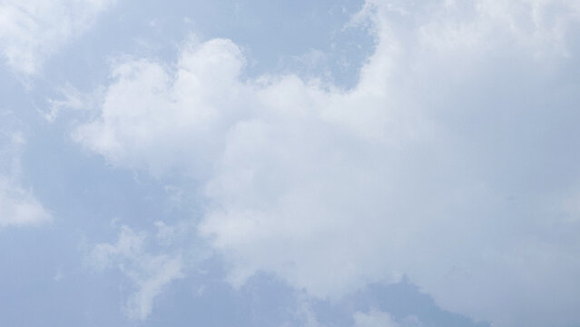 Soft Pale Blue Sky with Billowy White Cumulus Clouds