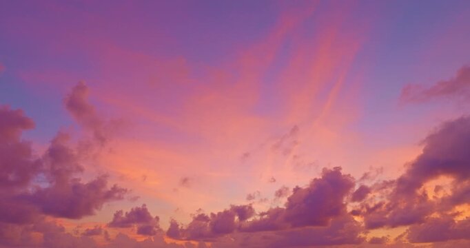 aerial view of pink cloud in blue sky at stunning sunset at the sea in sunset. 
Scene of clouds floating in colorful sky in beautiful sunset.
Gradient color. Sky texture, abstract nature background.