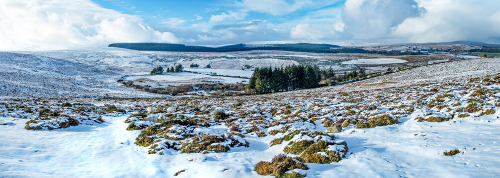 Vast landscape of the open moorland after snowfall. Rugged Granite rock of Haytor, Dartmoor national parkland. Devon's Tourist hotspot and iconic moorland. 