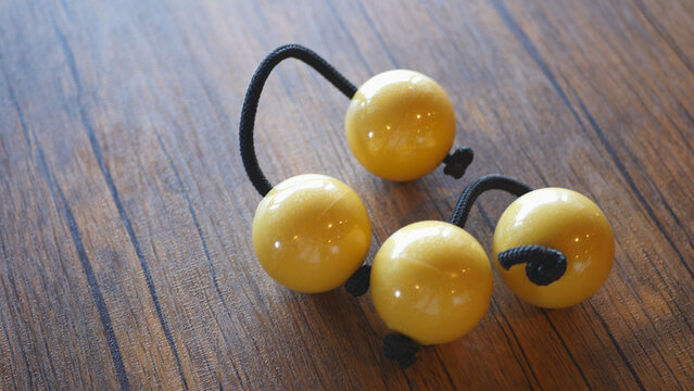 Close-up of yellow patica percussion instrument on wooden table
