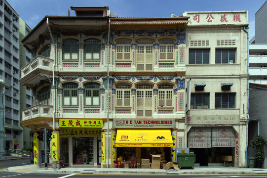 Historic Peranakan shophouse facade with colorful shuttered windows and traditional Straits Chinese architecture in Singapore