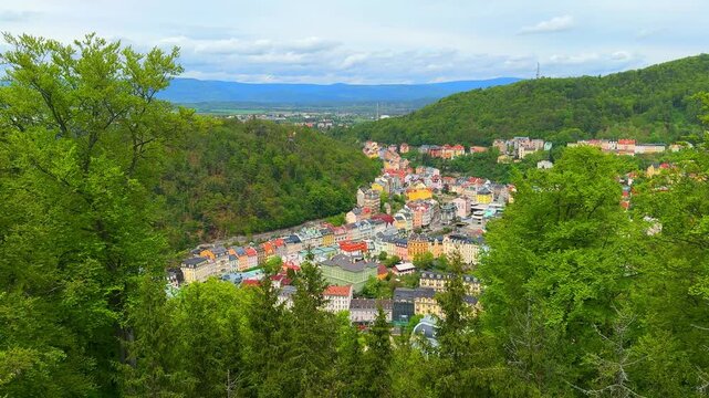 Views of Karlovy Vary from above and see the colorful buildings nestled among trees. This spot highlights the natural beauty and architecture of the area.