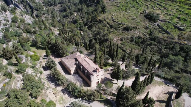 Orbital aerial shot of Ermita (Hermitage) De Sant Blai on sunny spring day. Tivissa, Tarragona, Spain.
