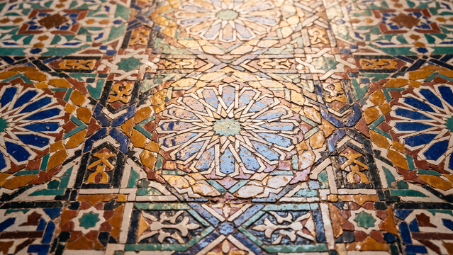 Close-up of intricate Moroccan zellige ceramic tiles featuring vibrant geometric Islamic patterns and handcrafted artistic details.
