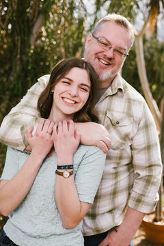 Happy father and daughter smiling together outdoors
