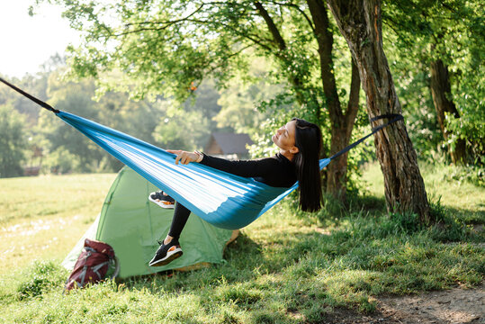 Sport girl sit on hammock and enjoy nice view