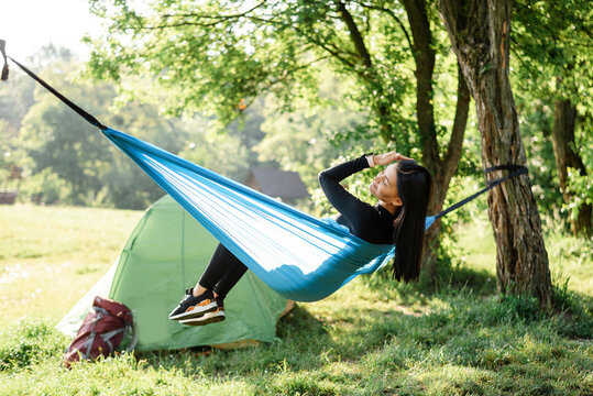 Sport girl sit on hammock and enjoy nice view
