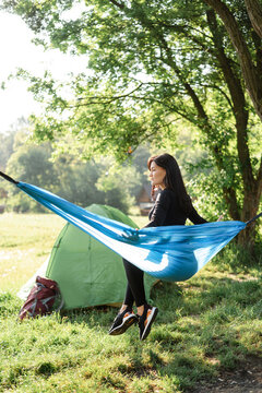 Sport girl sit on hammock and enjoy nice view
