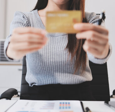 Young Asian business woman using smartphone and credit card for online shopping. Online Payment.