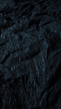 Dark Crumpled Rough Surface Texture. Macro view of raised irregular folds under cool directional light with slow camera movement. Suitable for abstract and grunge backgrounds.