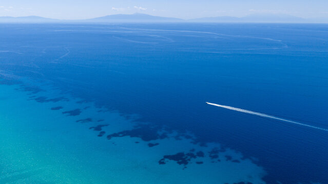 Aerial view of boat speeding over turquoise sea