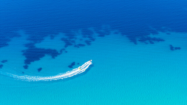 Speedboat turning on clear blue sea at Possidi beach Greece