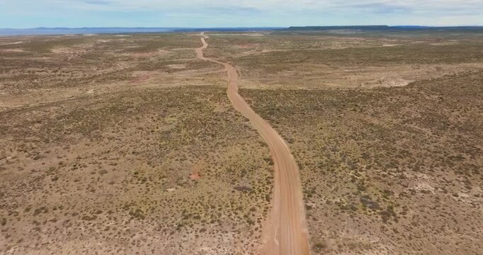 4K video, forward drone flight over arid landscape with unpaved road on the desolate pampas of Patagonia at the east coast of Argentina