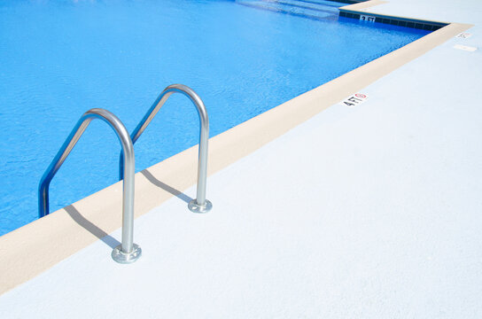 Edge of swimming pool on sunny day
