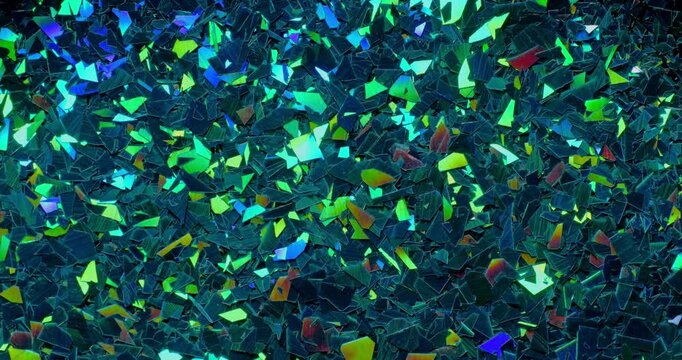 	
Iridescent holographic flakes slow rotation. Close-up of dense multicolored shiny fragments with vibrant reflections.