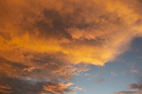 Storm clouds colored by setting sun