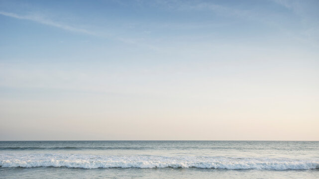 Pastel colored sky above calm Atlantic Ocean at dusk