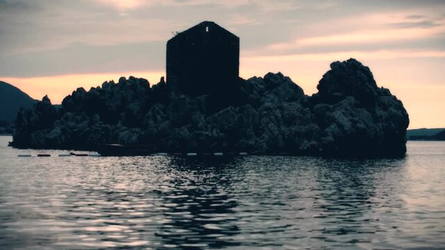 sunset with boat and island on the beach in Przno, Montenegro
