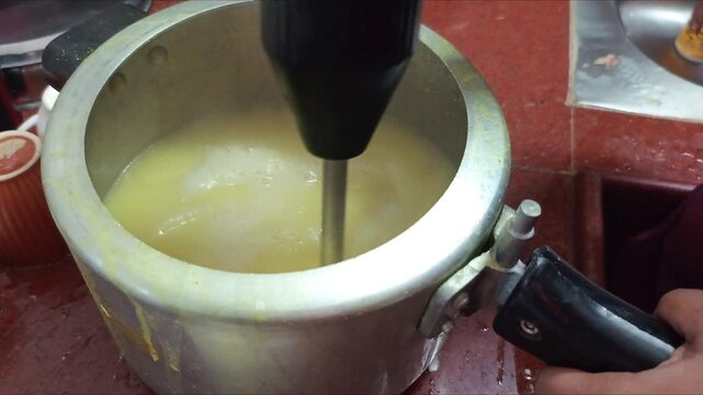 Blending Boiled Yellow Dal with Hand Blender in Pressure Cooker