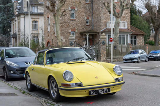 Nancy, France - March 3rd 2019 : View on a yellow Porsche 911T Targa parked on a street.