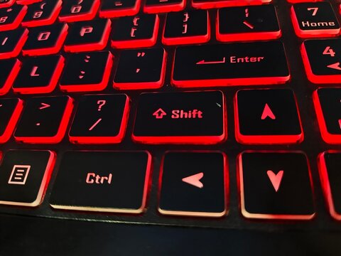 Macro view of computer keyboard with red led backlight and navigation keys keyboard navigation