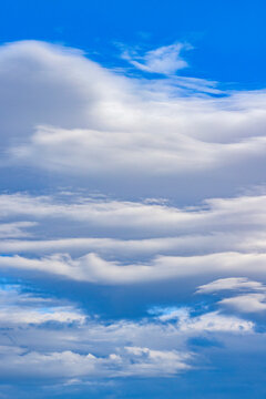 White lenticular clouds on blue sky