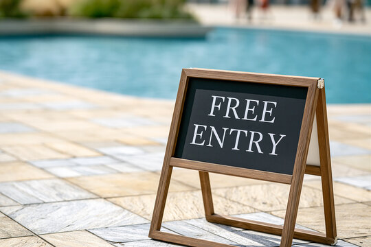 FREE ENTRY A-frame sign beside a swimming pool