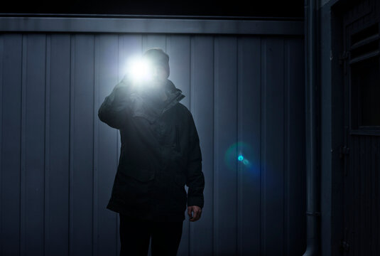 Watchman searching site with torchlight