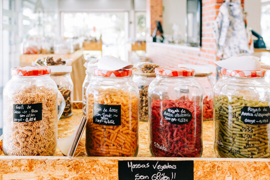 Colorful raw pasta in glass jar at a zero waste bulk food store