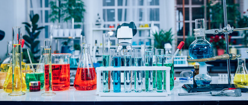 Laboratory research, microscope with lab glassware, science laboratory research and development concept.