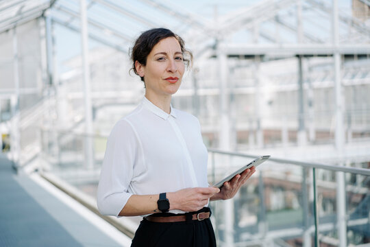 Portrait of a confident businesswoman holding tablet