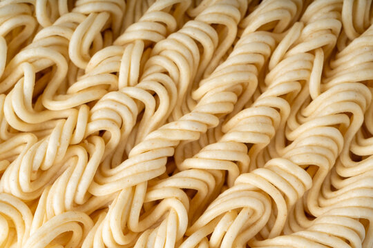Instant noodles texture background, dry ramen noodle macro pattern