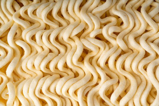 Instant noodles texture background, dry ramen noodle macro pattern