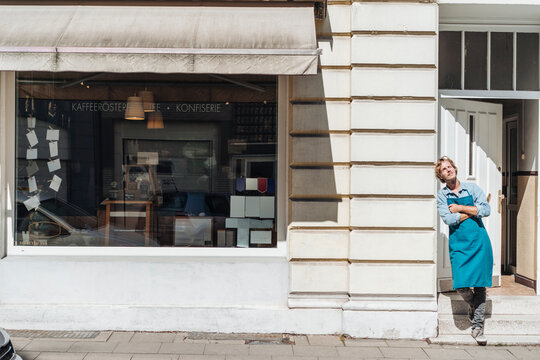 Coffee roaster standing in front of his his shop
