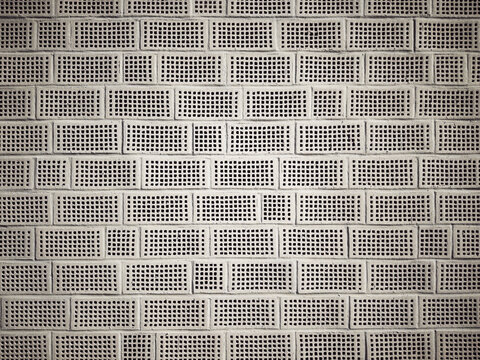 Full frame of gray bee wall with square holes