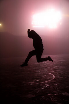 Silhouette jumping in mysterious foggy night in Sapa Vietnam