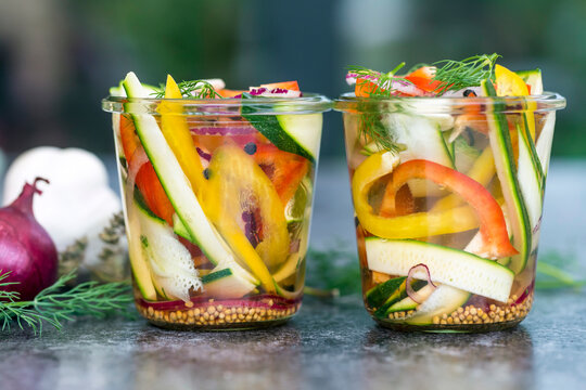 Pickeled vegetables and herbs in bowls