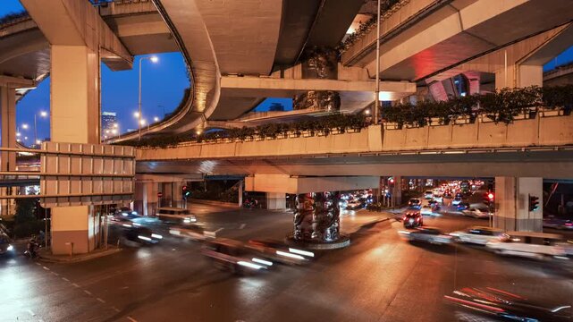 Asia, China, Shanghai, day to night cityscape zoom in time lapse of road intersection in central Shanghai, busy with rush hour traffic and commuters